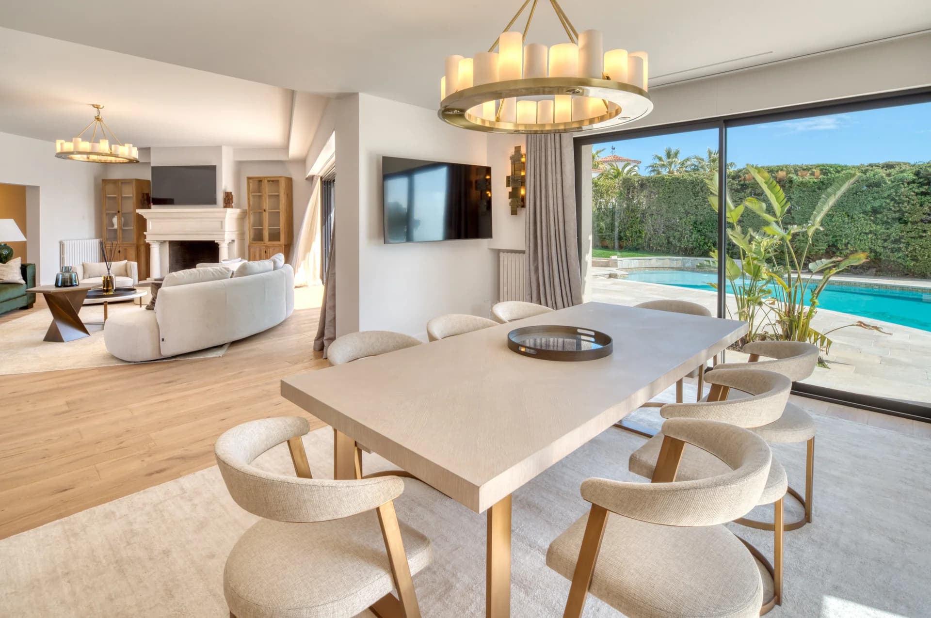 Salle à manger ouverte sur le salon, baie vitrée côté piscine