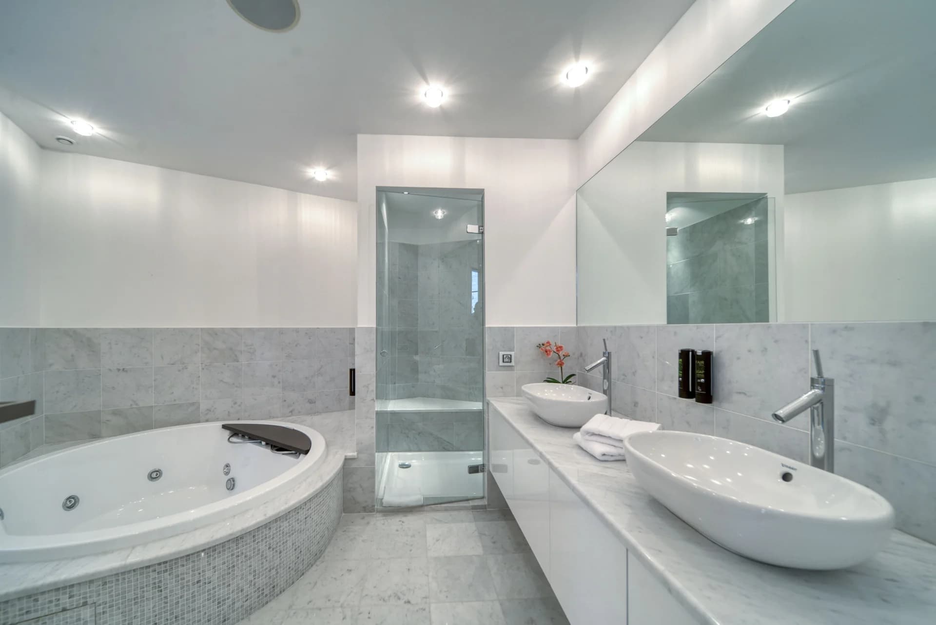 Salle de bain avec baignoire jacuzzi et double vasque