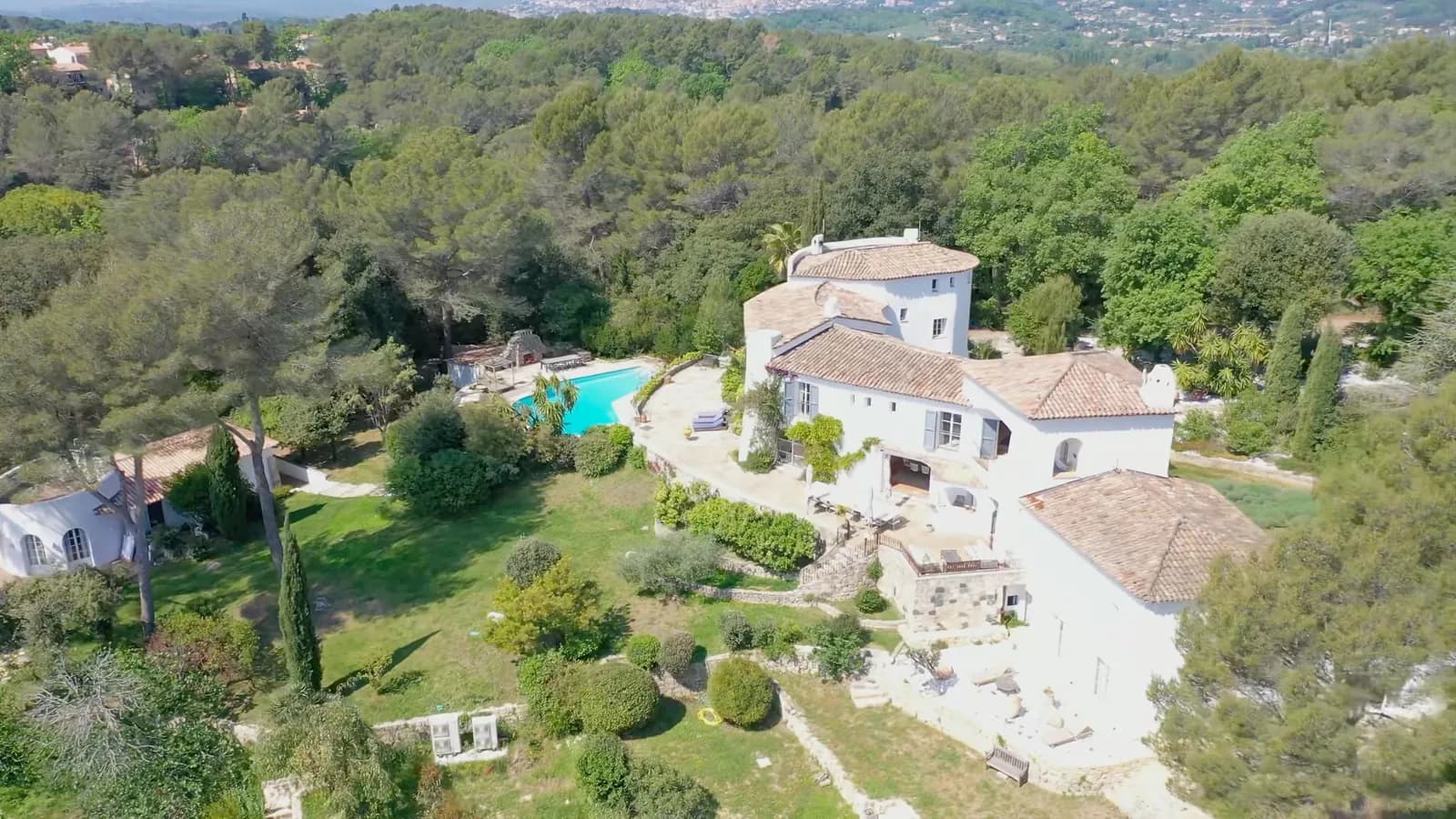 Aerial view of Domaine de Châteauneuf at Valbonne: the round-towered villa, the stone terrace and the pool set in the grounds